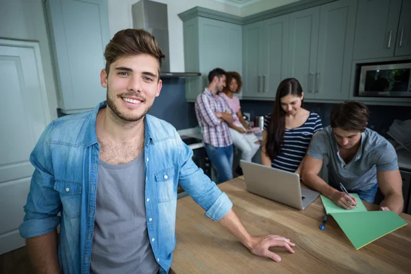 Man with friends in background — Stock Photo, Image