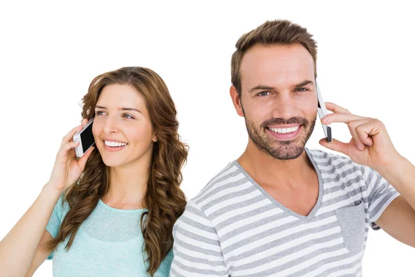 Couple talking on mobile phones — Stock Photo, Image