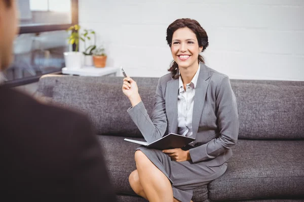 Mujer de negocios sentada en un sofá en la oficina — Foto de Stock