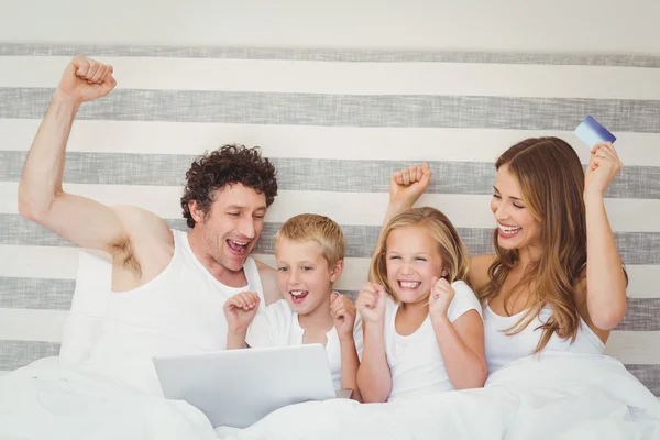 Family enjoying on bed — Stock Photo, Image