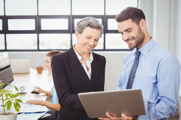 Business people looking in digital tablet — Stock Photo, Image