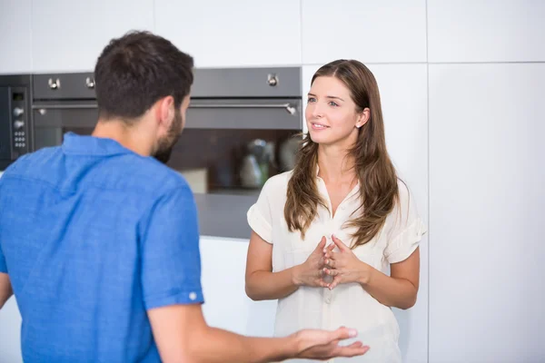 Man explaining wife in kitchen — Stock Photo, Image