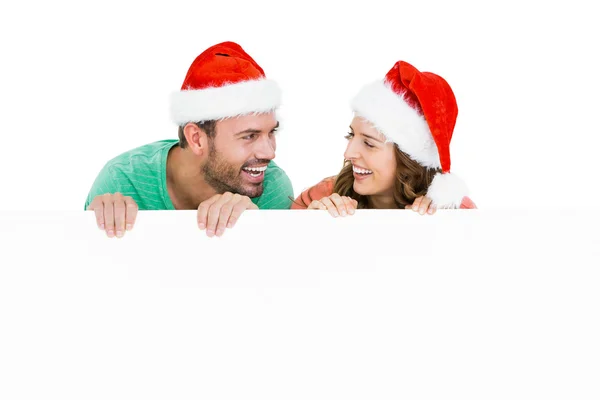 Couple wearing santa hats — Stock Photo, Image