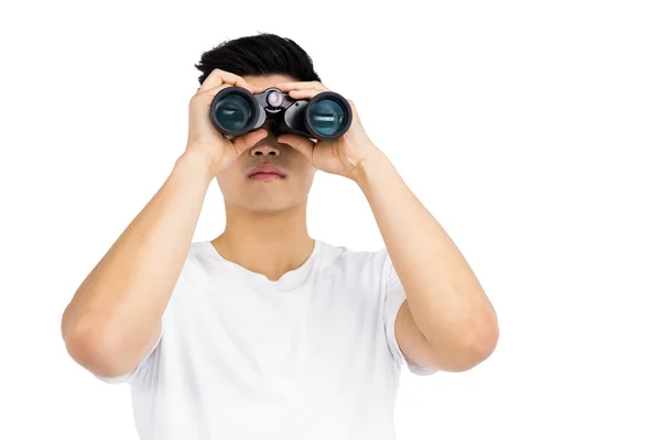 Man looking through binocular — Stock Photo, Image