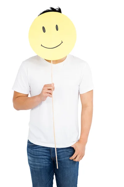 Man håller smiley face — Stockfoto