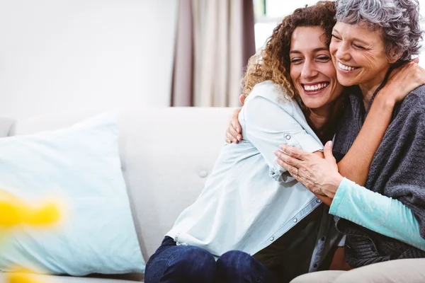 Smiling mother and daughter hugging — Stock Photo, Image