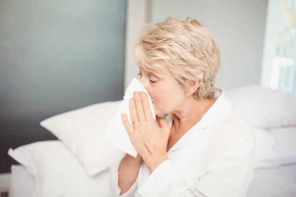 Senior woman covering nose — Stock Photo, Image