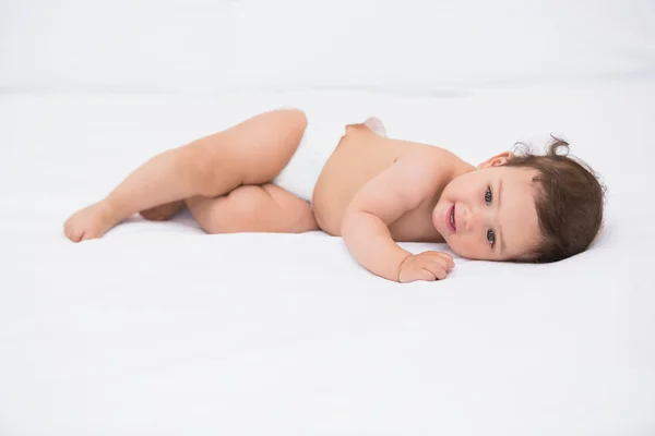 Close-up of baby lying on bed — Stock Photo, Image