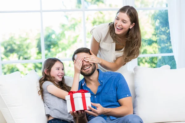 Man surprised with gift in sofa — Stock Photo, Image