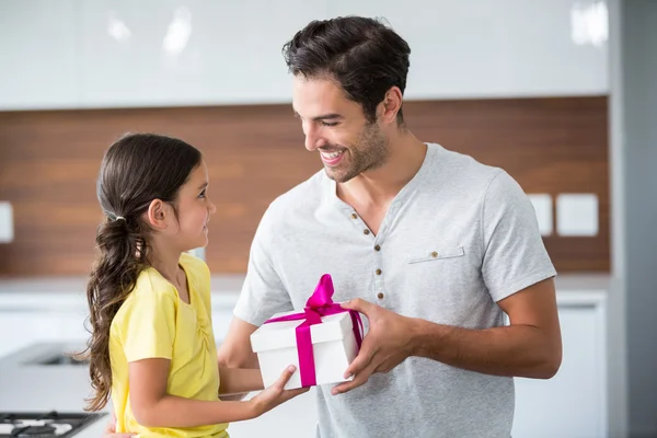 Daughter giving gift box to father — Stock Photo, Image