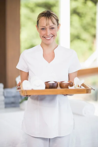 Masseur holding tray with spa products — Stock Photo, Image