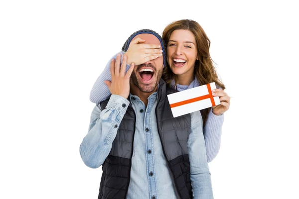 Woman giving surprise gift to man — Stock Photo, Image