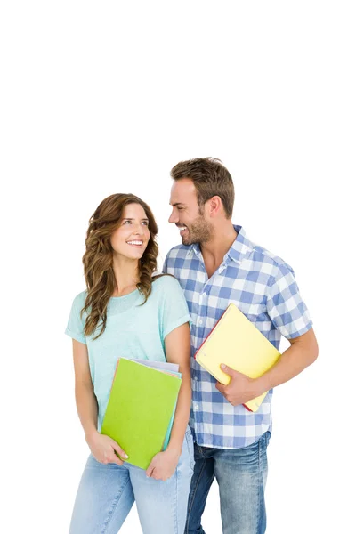 Casal segurando livros e pastas — Fotografia de Stock