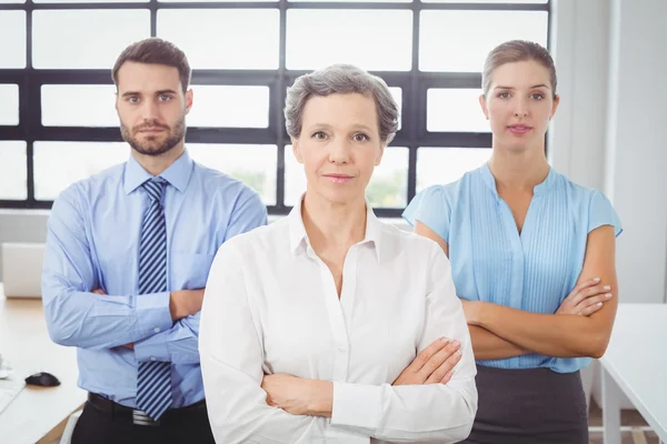 Business people by desk in office — Stock Photo, Image