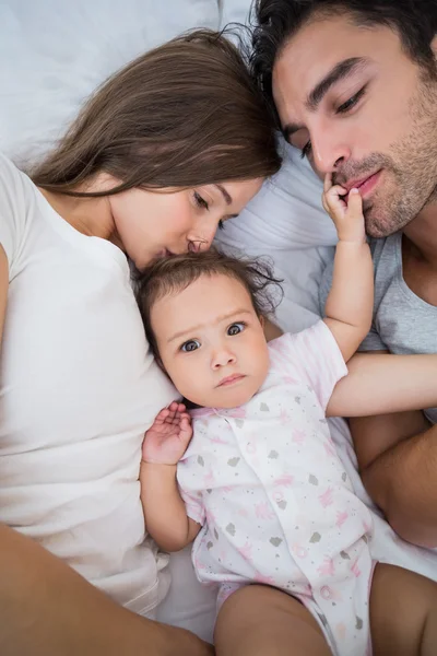 Close-up of family lying on bed — Stock Photo, Image