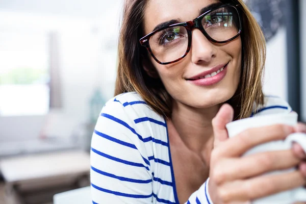 Wanita tersenyum sambil memegang kopi — Stok Foto