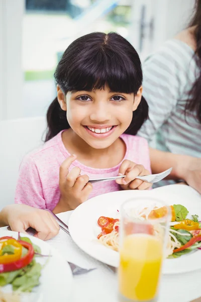 Girl sitting at dining table Royalty Free Stock Images