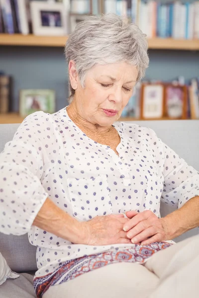 Senior woman suffering from stomach pain — Stock Photo, Image