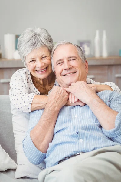 Senior couple hugging on sofa — Stock Photo, Image