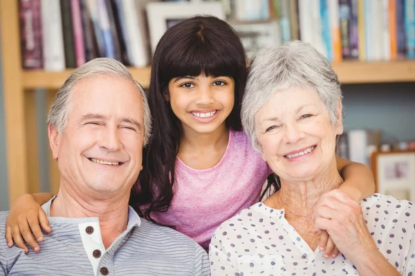 Granddaughter with grandparents at home — Stock Photo, Image