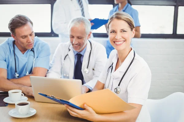 Doctor holding medical report — Stock Photo, Image