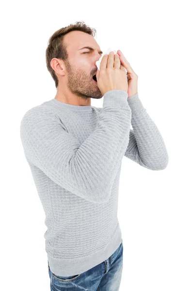 Man holding tissue and sneezing — Stock Photo, Image