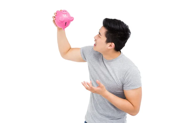 Homem segurando Piggy Bank — Fotografia de Stock