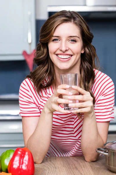 Mujer con vaso de beber en la mesa — Foto de Stock