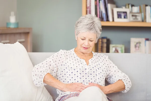 Senior woman suffering from stomach pain — Stock Photo, Image