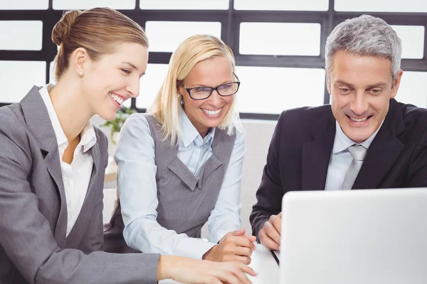 Business people looking in laptop — Stock Photo, Image