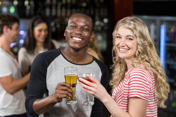 Freunde stoßen mit Cocktail und Bier an — Stockfoto