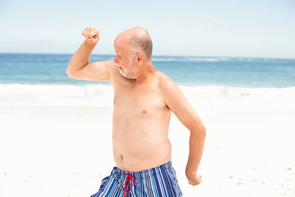 Senior man poseren met zijn spieren — Stockfoto