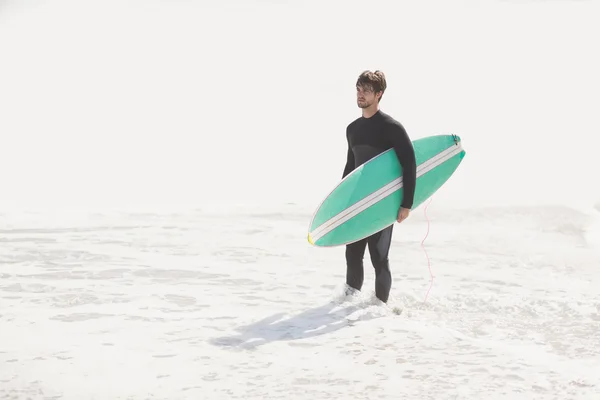 Mann mit Surfbrett am Strand — Stockfoto