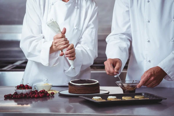 Cuochi che decorano una torta — Foto Stock