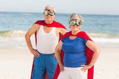 Senior couple wearing superman costume clipart