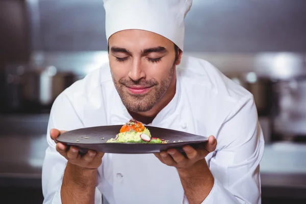 Chefe masculino com olhos fechados cheirando comida — Fotografia de Stock