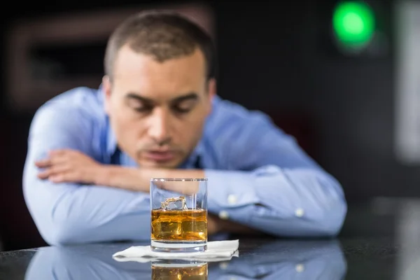 Worried businessman drinking a beer — Stock Photo, Image