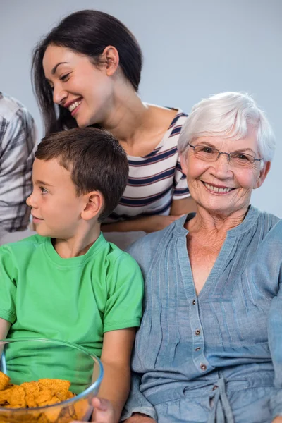 Familia feliz sentado en el sofá — Foto de Stock