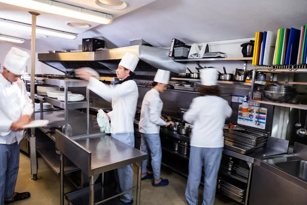 Chefs preparing food in kitchen — Stock Photo, Image