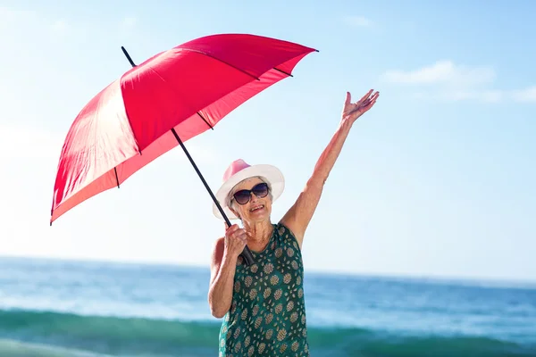 Senior woman posing with an umbrella — Stock Photo, Image