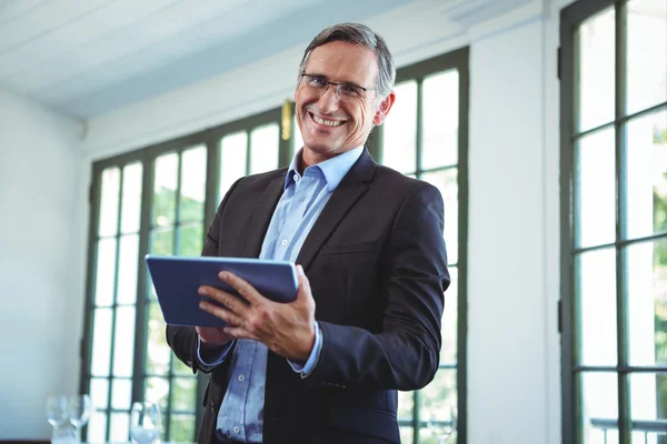 Smiling businessman using a tablet — Stock Photo, Image