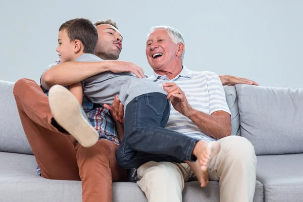 Son embracing father in living room