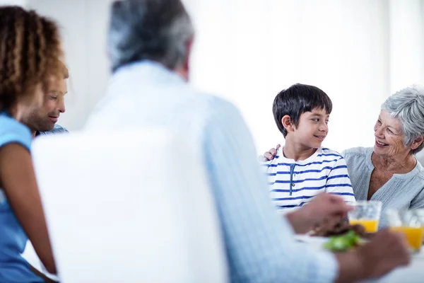 Grandmother and grandson having breakfast with family — Stock Photo, Image