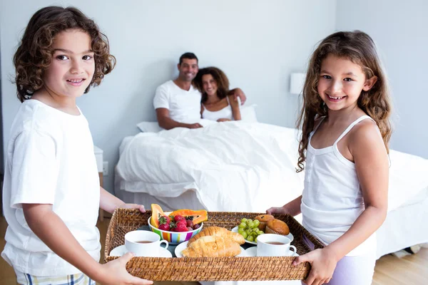 Daughter and son carrying breakfast tray — Stock Photo, Image