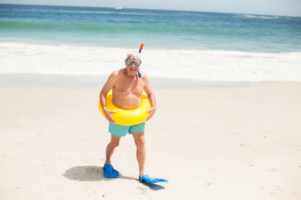 Homem sênior com anel de natação e barbatanas na praia — Fotografia de Stock