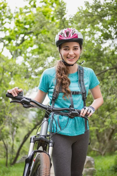 Woman pushing her bike — Stock Photo, Image