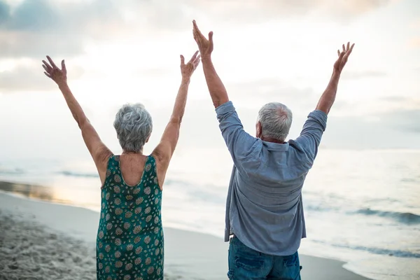 Senior couple raising their arms — Stock Photo, Image