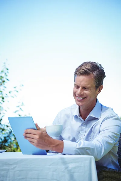 Businessman using tablet with coffee — Stock Photo, Image