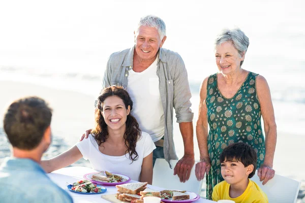 Happy family having a picnic at the beach — Stock Photo, Image