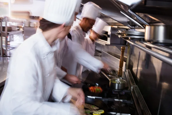 Chef frying fish in a frying pan — Stock Photo, Image